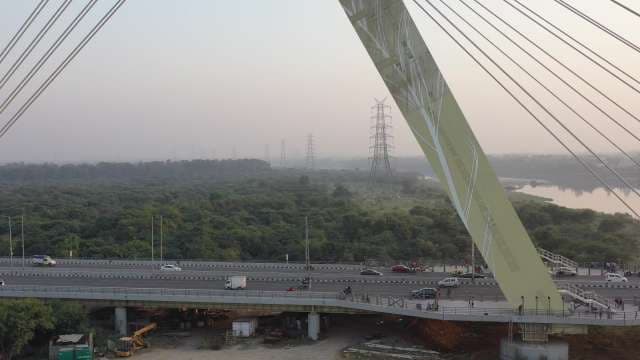 Modern Signature Bridge Over Yamuna River Amid Green Landscape