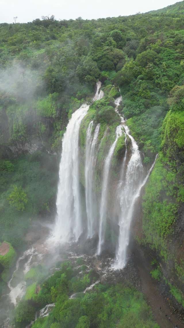 Majestic Baba Waterfall Cascading Through Lush Tropical Forest