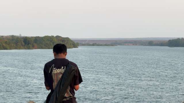 A Boy Sitting In Front Ff River Mahanadi 