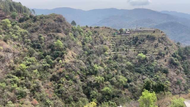 Panoramic View of Lush Green Mountains and Terraced Hillside