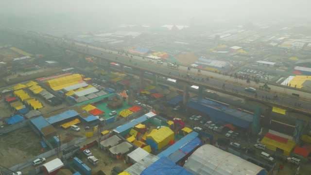 Aerial View of Foggy Market Tents Under Elevated Bridge