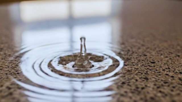 Water Drop Ripple on Textured Granite Surface