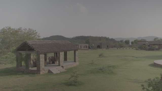 Rustic Stone Gazebo in Green Field with Mountain View