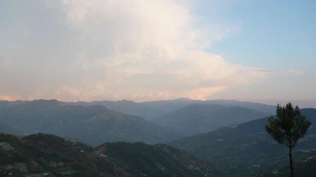 Panoramic View of Misty Mountain Ranges at Sunset