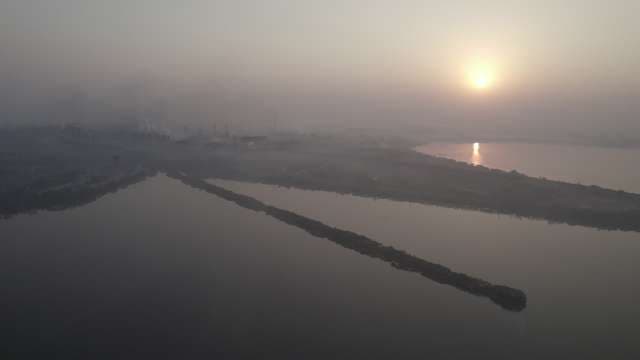 Industrial Air Pollution and Smoke Over River at Sunrise