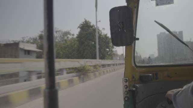 POV Shot of Auto Rickshaw Moving Through Hazy Indian City