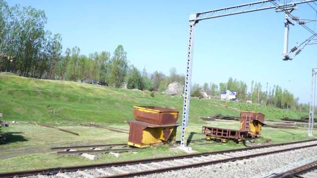 Rusty Industrial Railway Carts on Rural Tracks