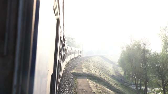 Scenic Train Journey Through Sunny Rural Landscape