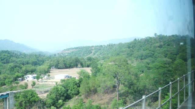 Scenic Train View of Lush Green Hills and Rural Valley
