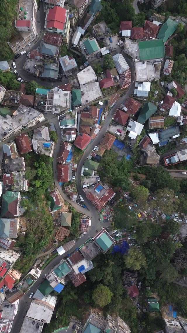 Aerial Top View of Dense Hillside City Buildings