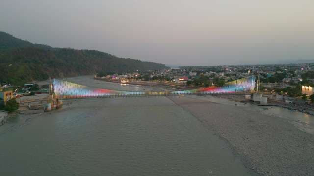 Illuminated Janki Setu Bridge over Ganges River in Rishikesh at Twilight