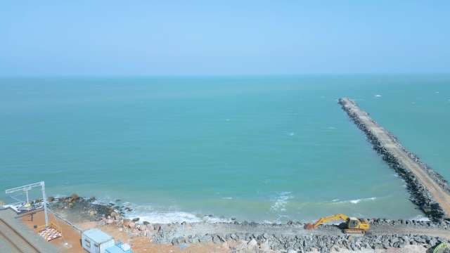 Aerial View of Coastal Railway Construction and Ocean Breakwater