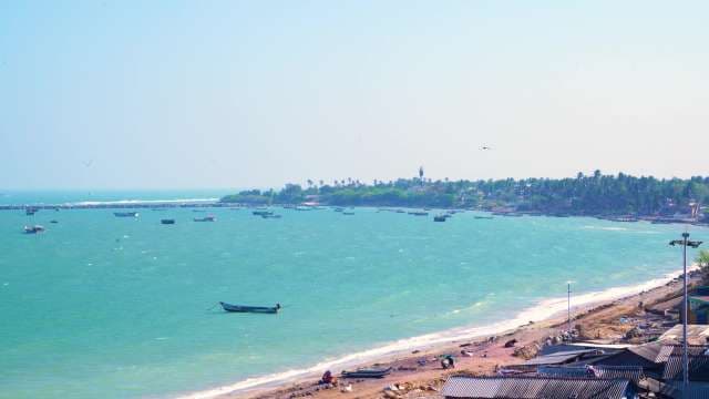 Aerial View of Tropical Coastline with Fishing Boats and Lighthouse